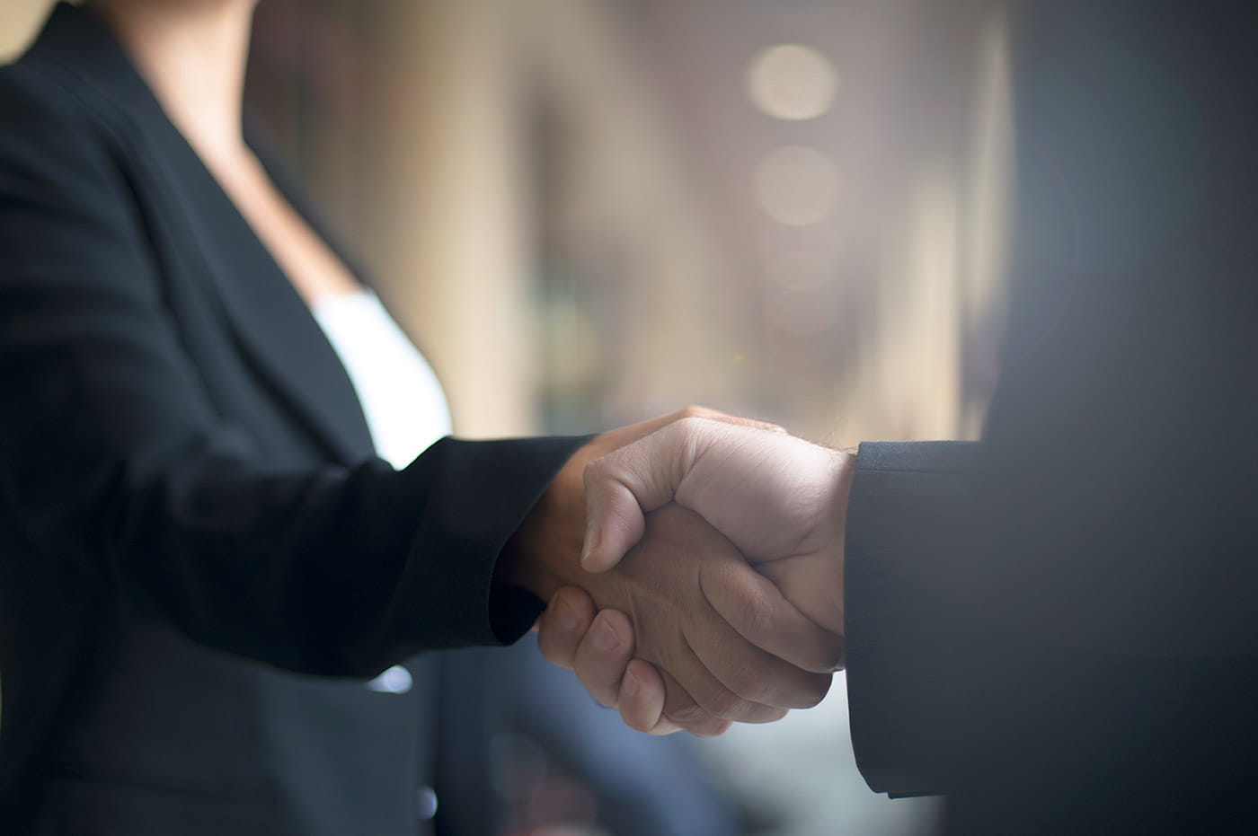 A closeup of two people shaking hands.