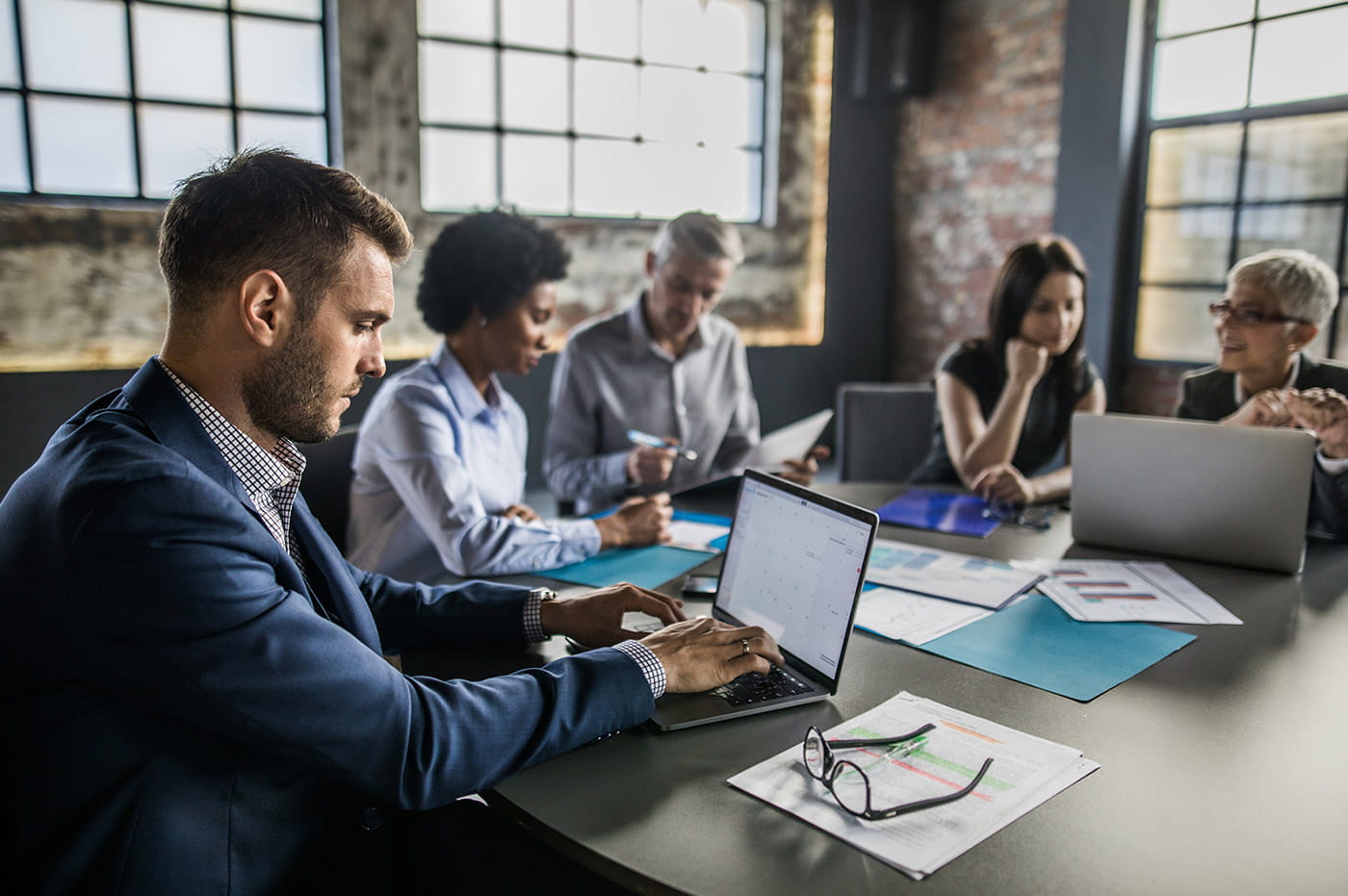 A group of professionals meeting and working together.