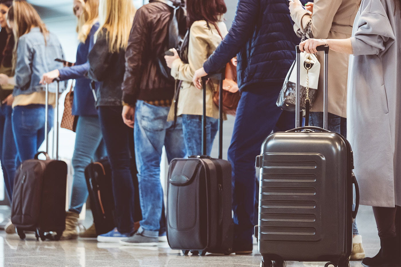 A line of travelers with suitcases.