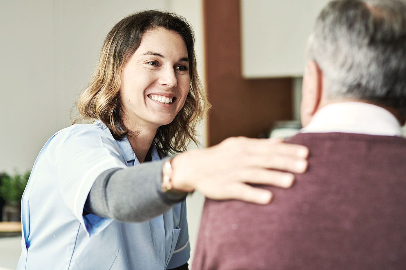 A female healthcare worker with a patient.