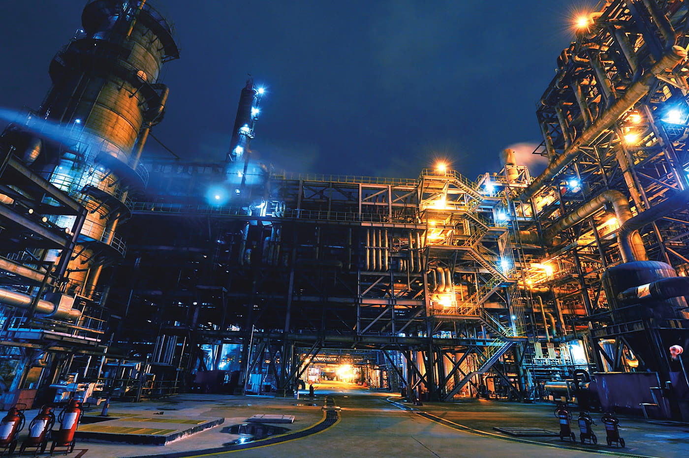 An energy plant lit up at night.