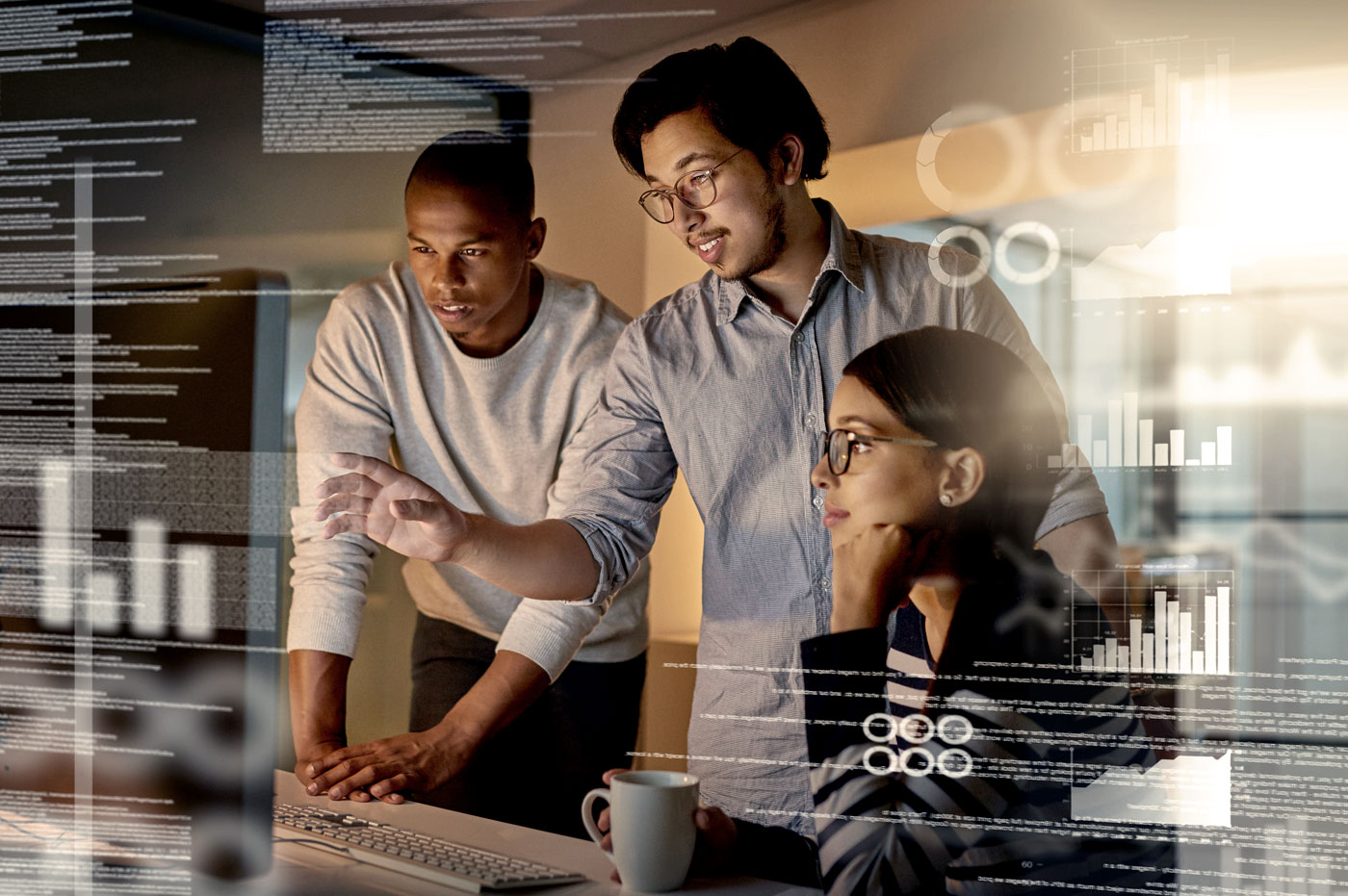 Three young professionals working together and discussing data.