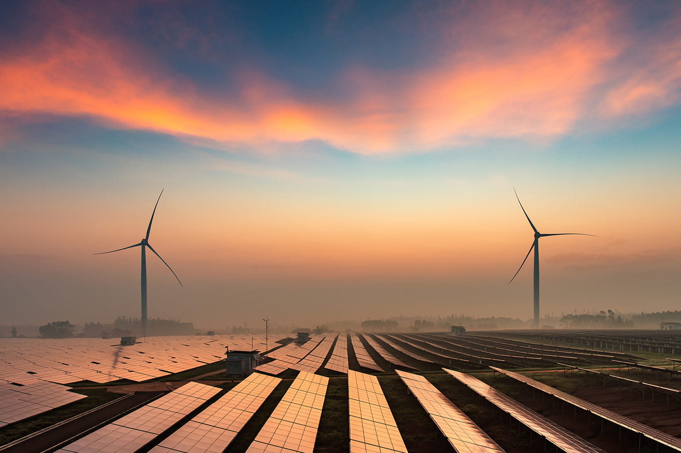 Wind turbines against a colorful sky