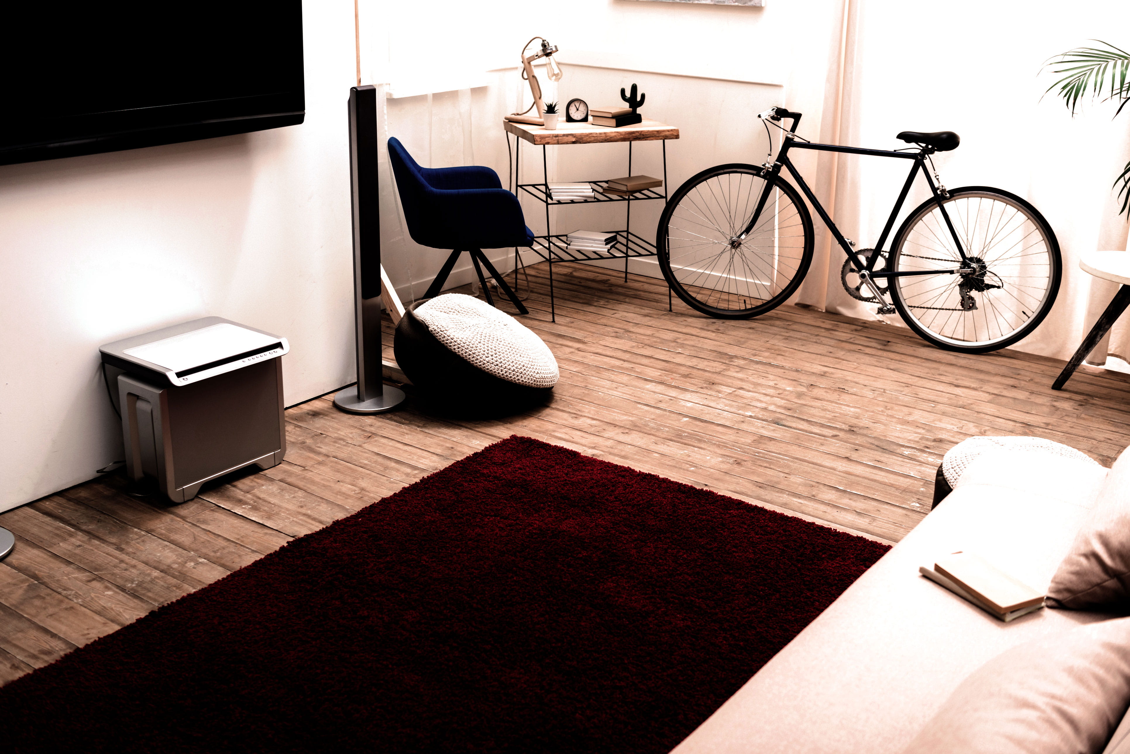 A dark red area rug in a living room.
