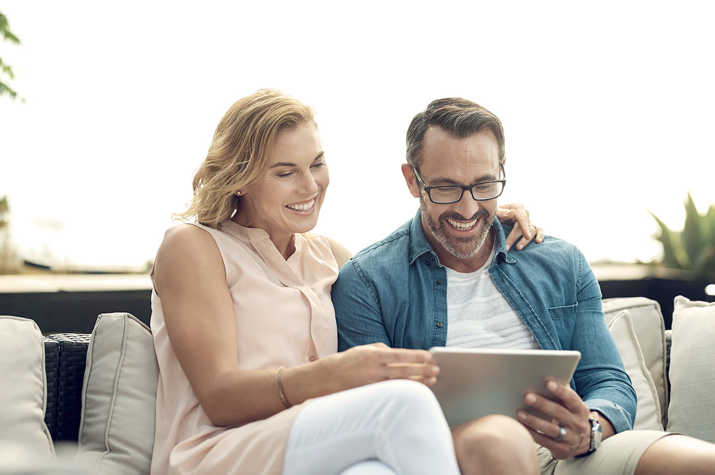 Two people looking at information on a tablet together.