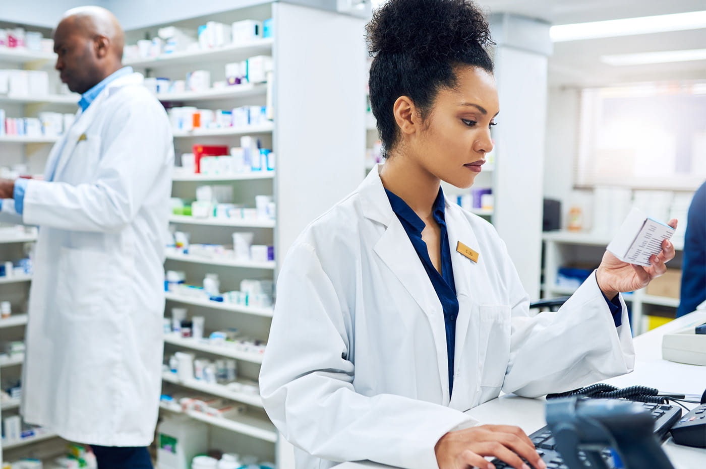 Man and woman doctors working in a pharmacy