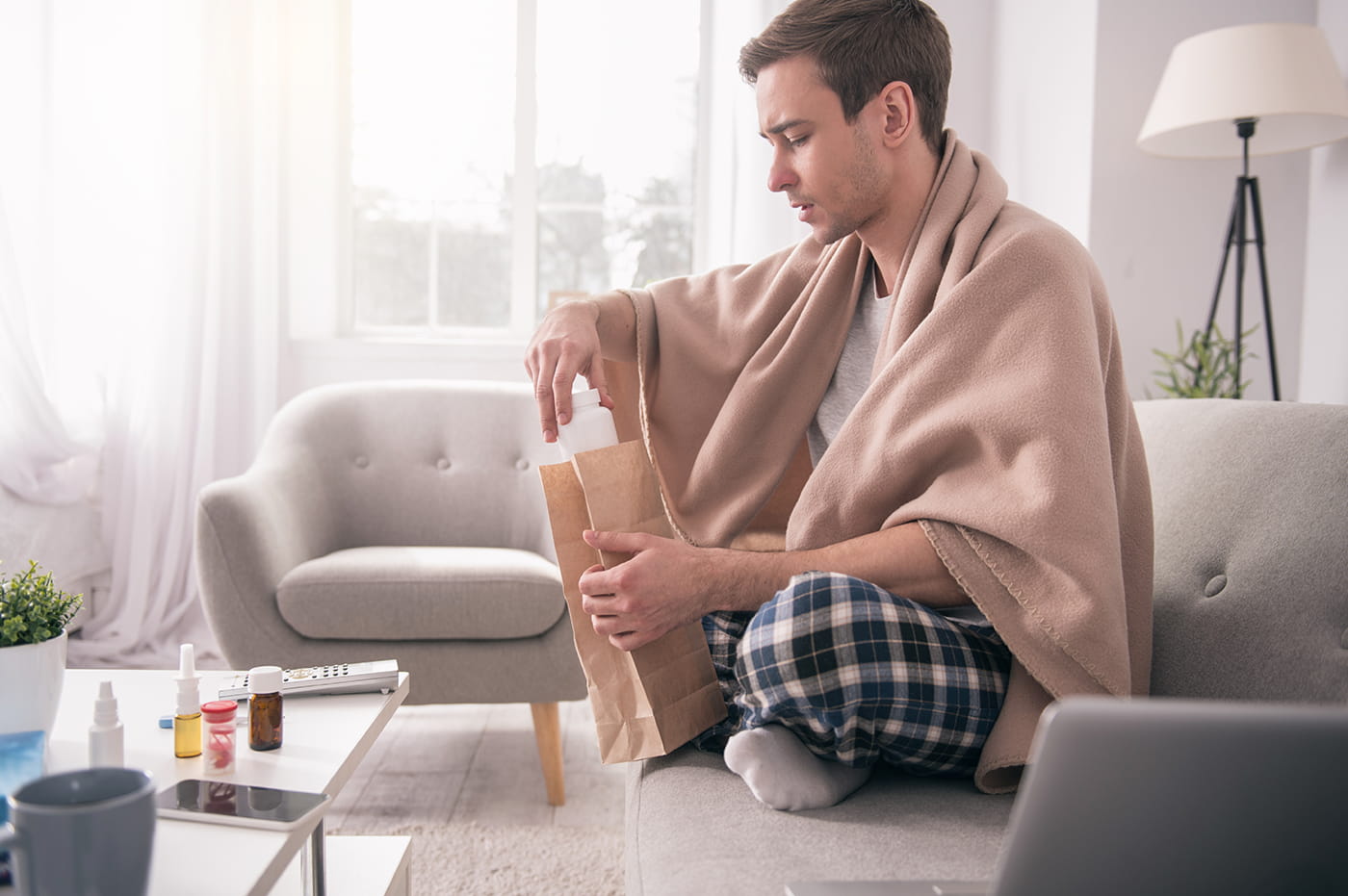 A person taking medication for their cold. 