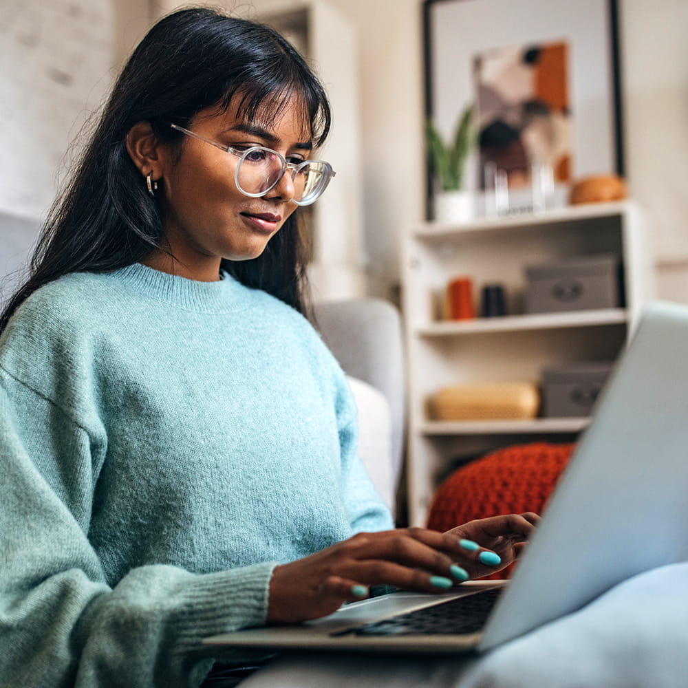 A woman working on a laptop.