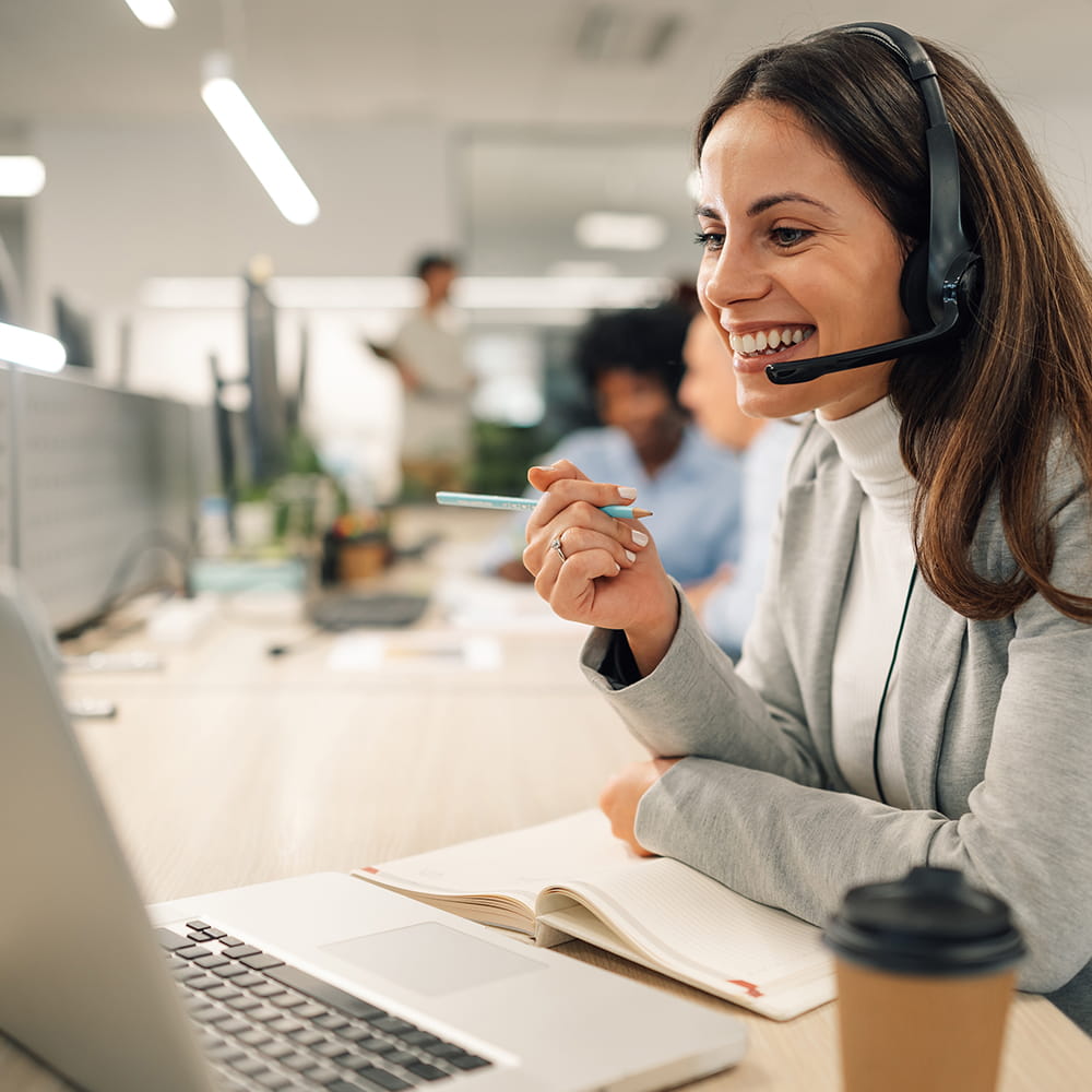 A woman talking on a headset.
