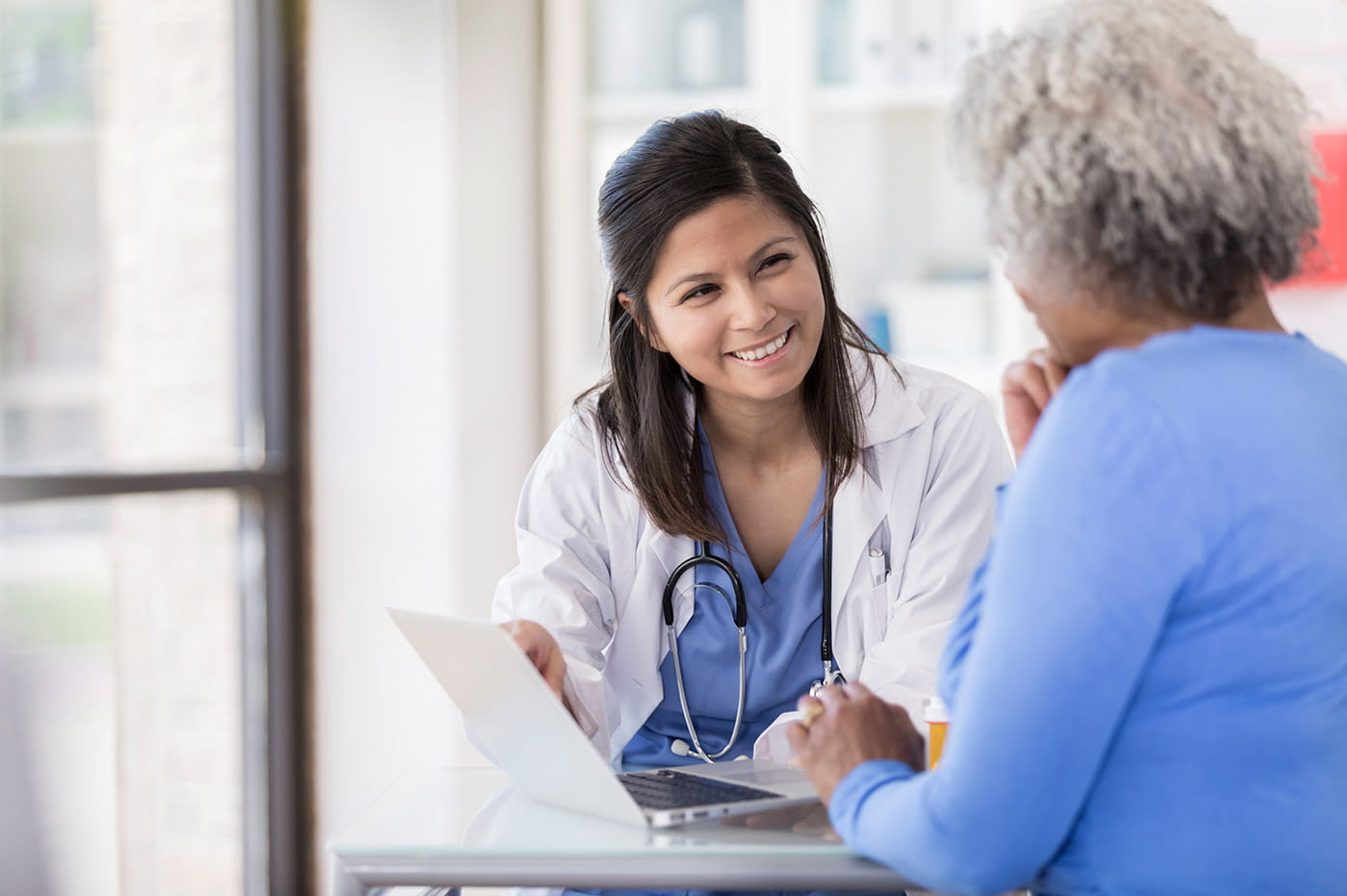 A female healthcare worker talking to her patient.