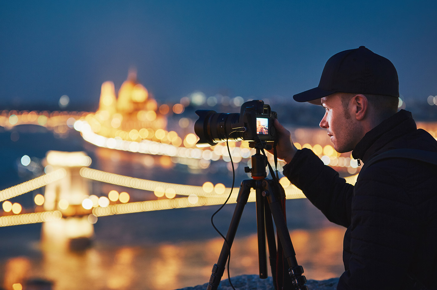 A man using a digital camera to take some photographs.