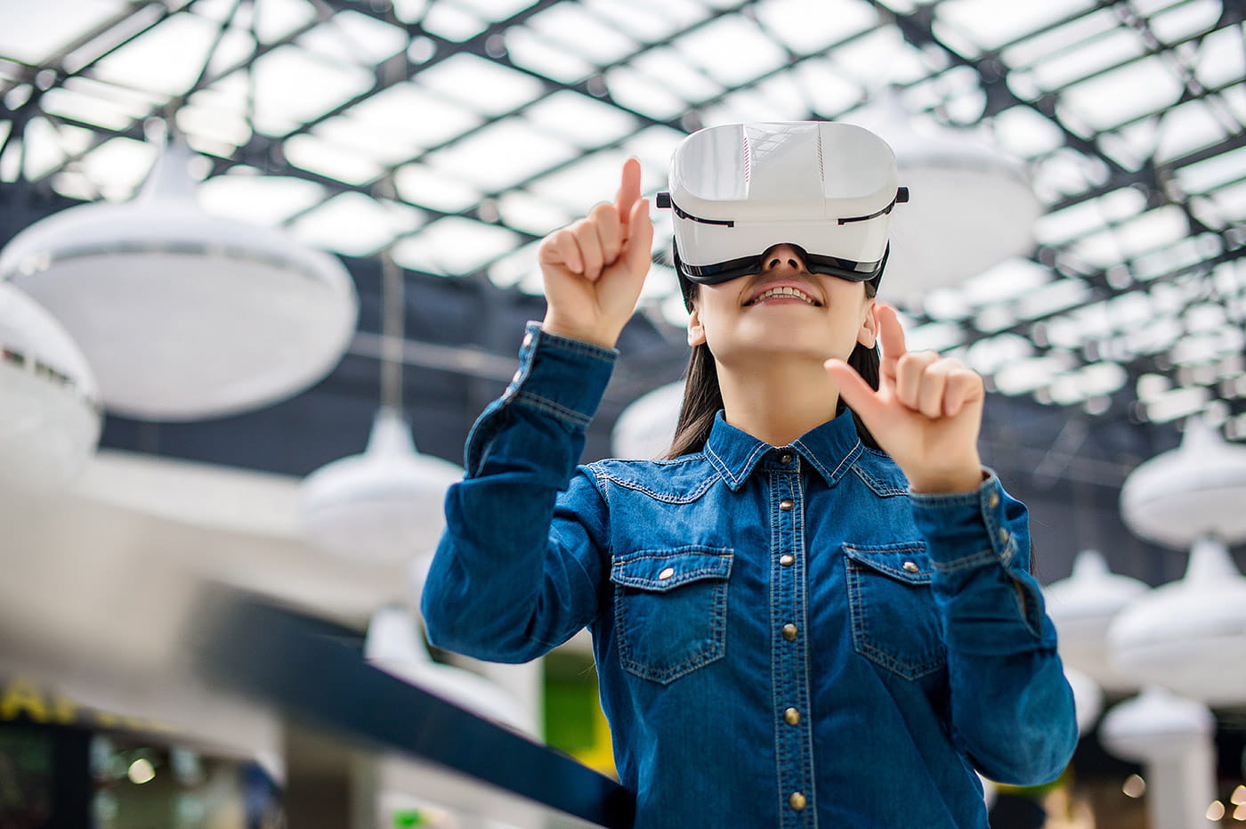 A young woman using a virtual reality headset.