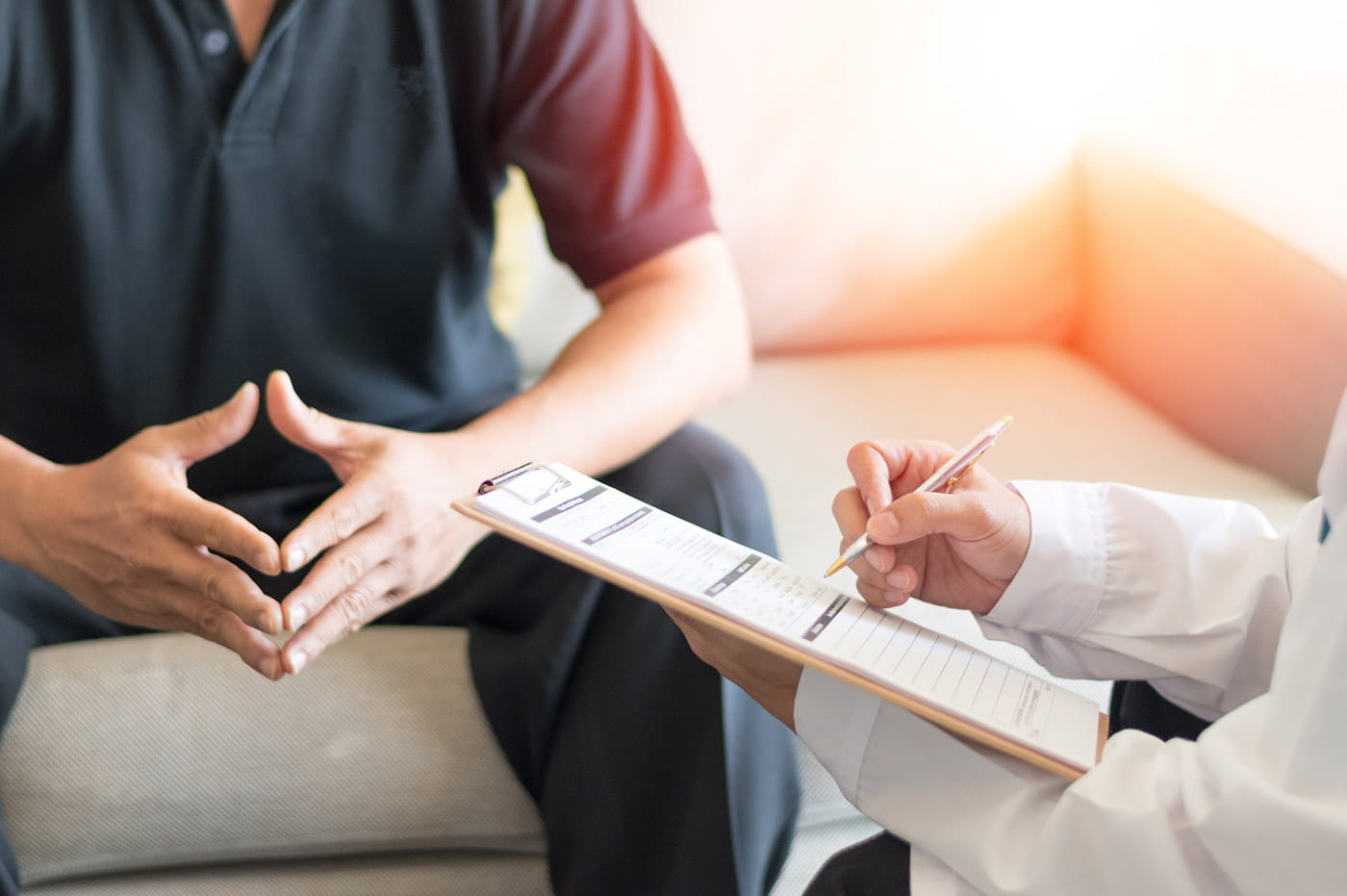 A doctor and patient reviewing some paperwork together.