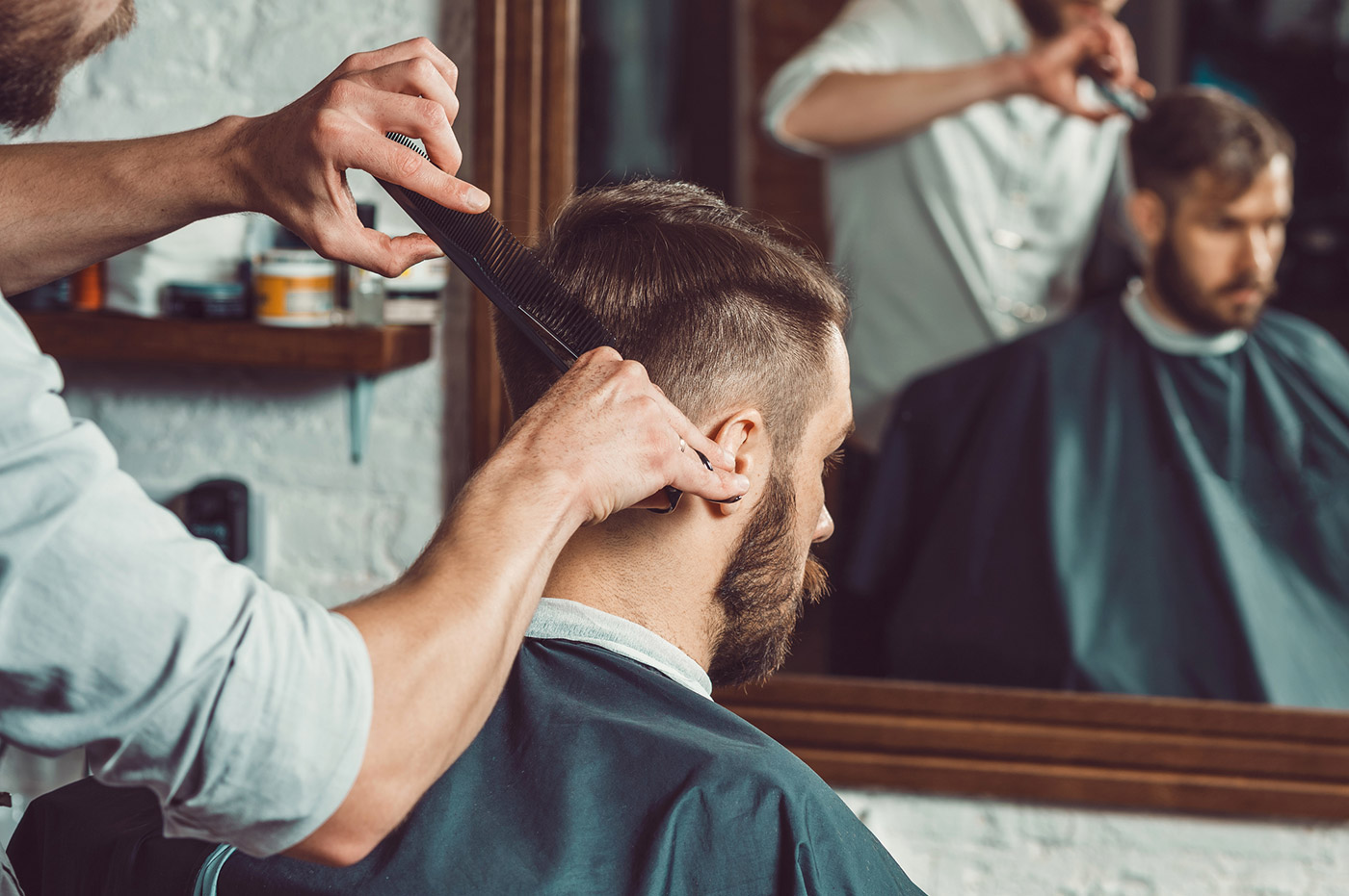 A young man getting his hair cut.