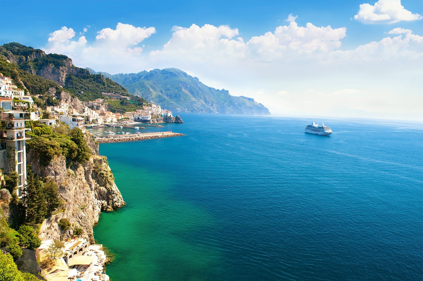 Vibrant blue ocean waters and a cruise ship.