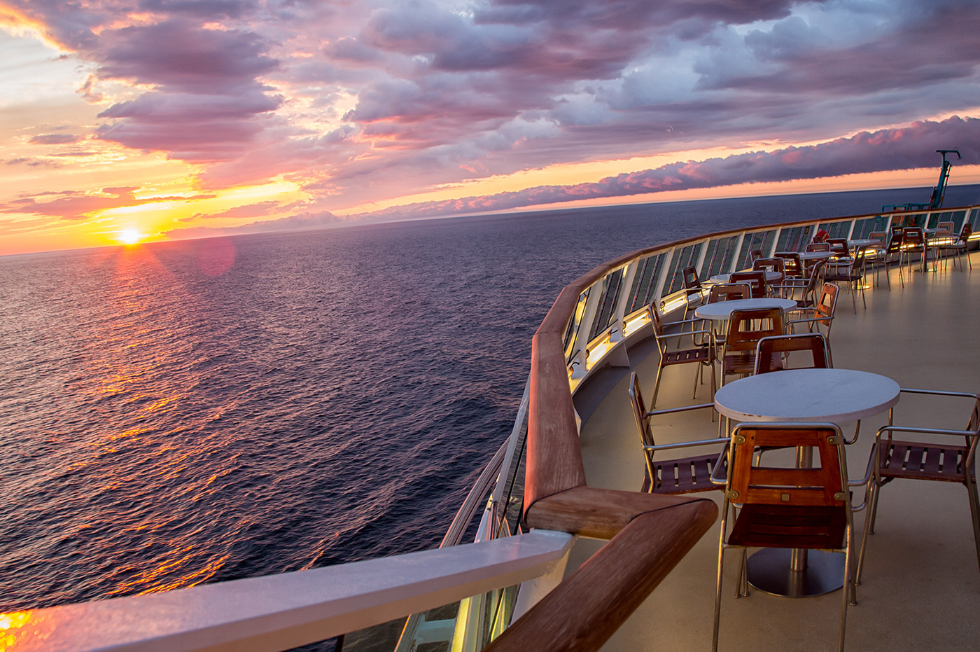 The ocean at sunset from the deck of a cruise ship.