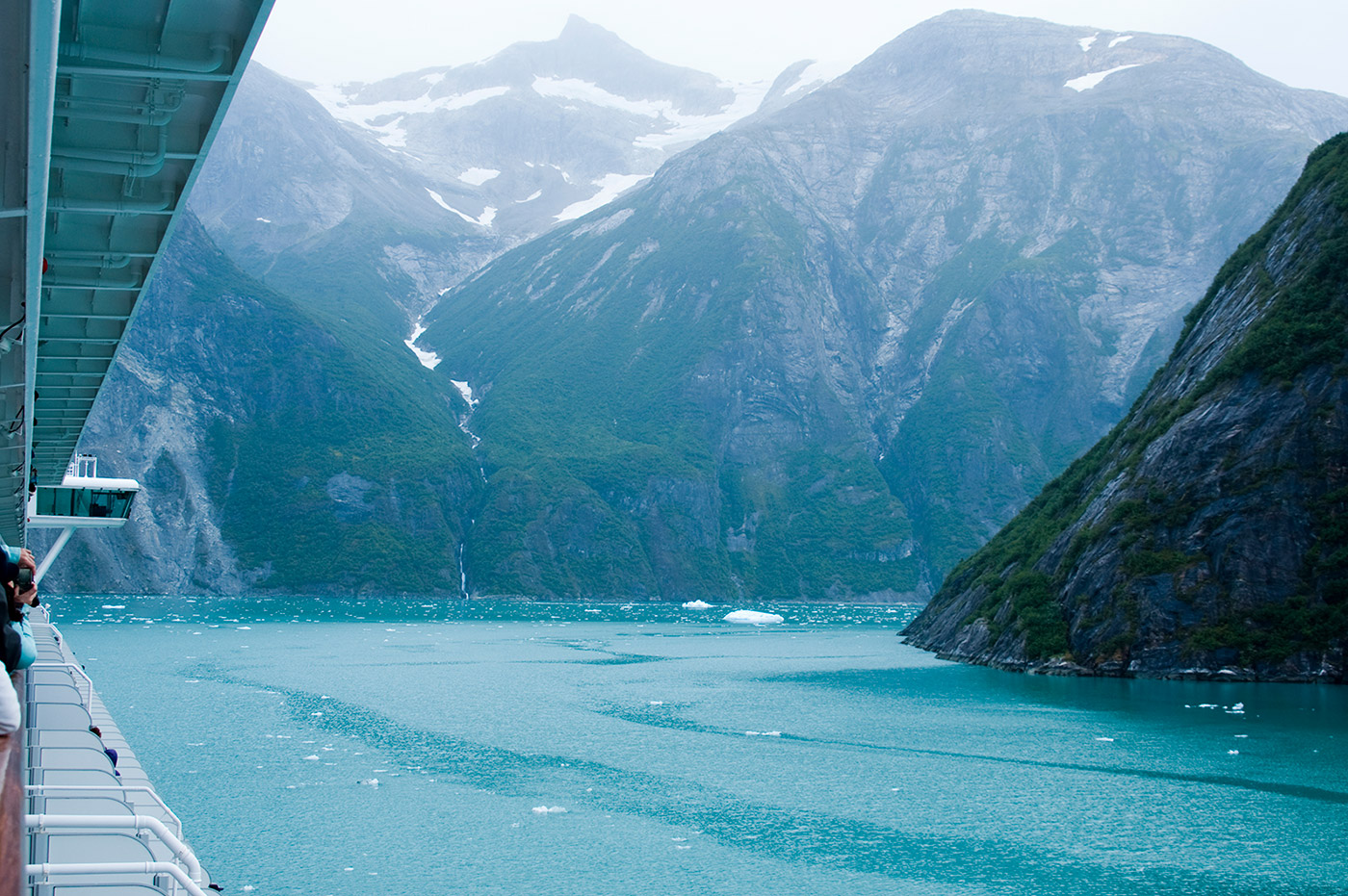Icy waters and snow-capped mountains from the deck of a cruise ship.