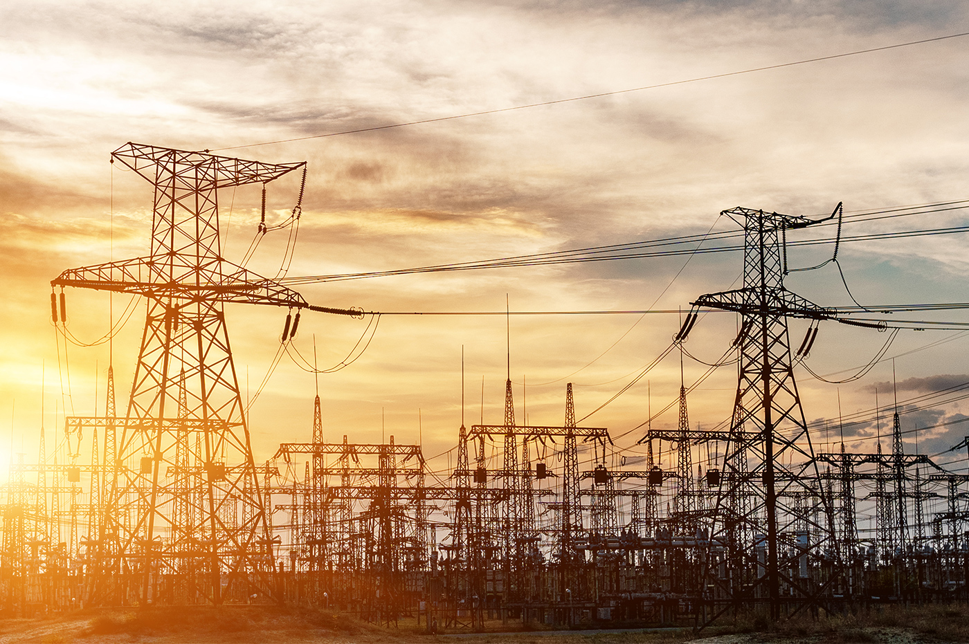 A powerplant and energy towers at sunset.