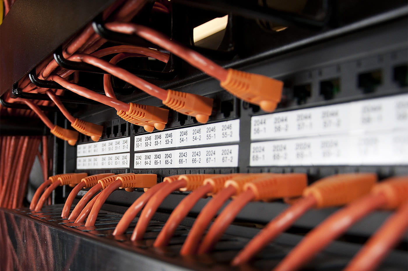 Various orange electrical cords plugged in.