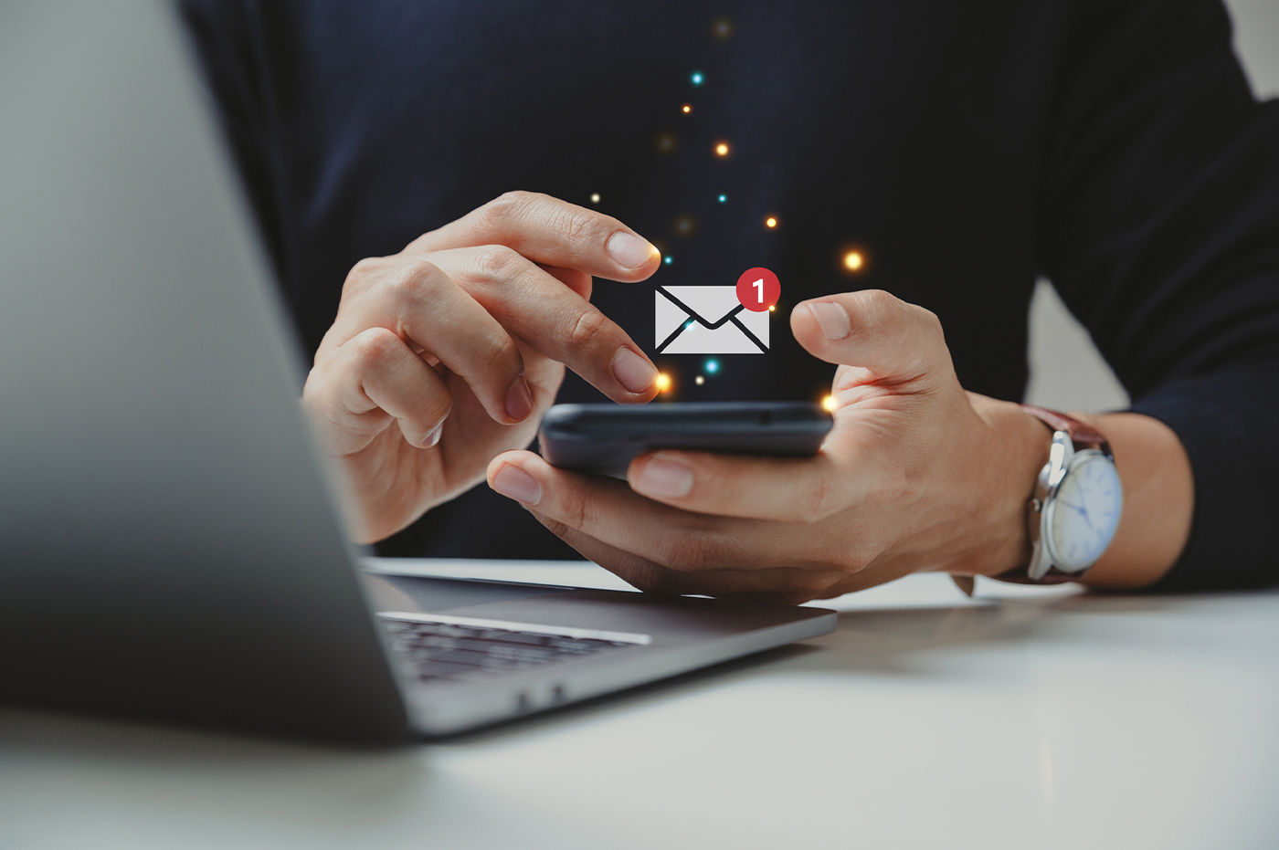 Man holding phone with email icon popping up