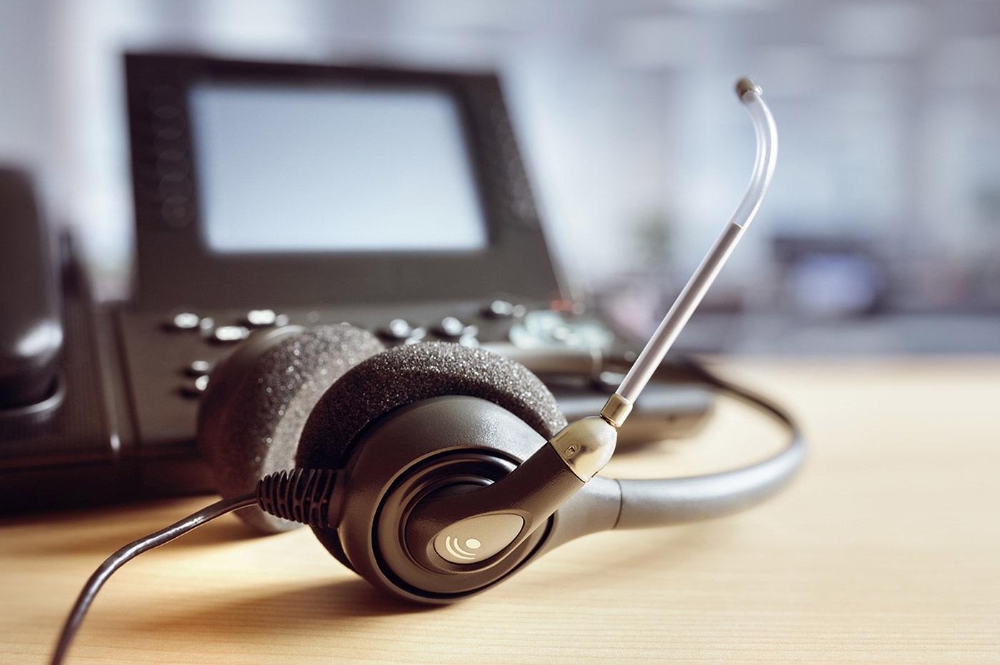A desk phone with a headset attached.