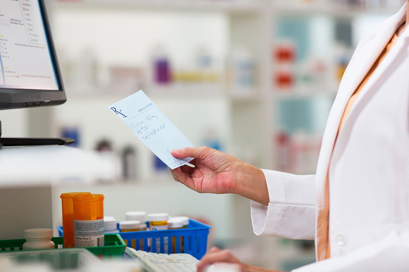 A pharmacist looking at a prescription from a healthcare provider.