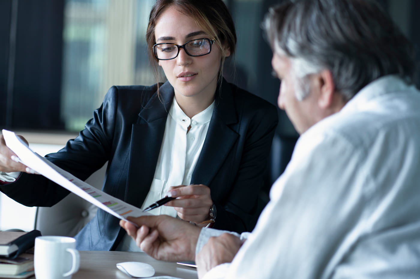 Two people going over some data and information together.