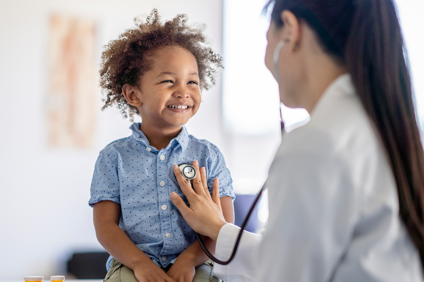 A Healthcare worker checking a child's heartbeat. 