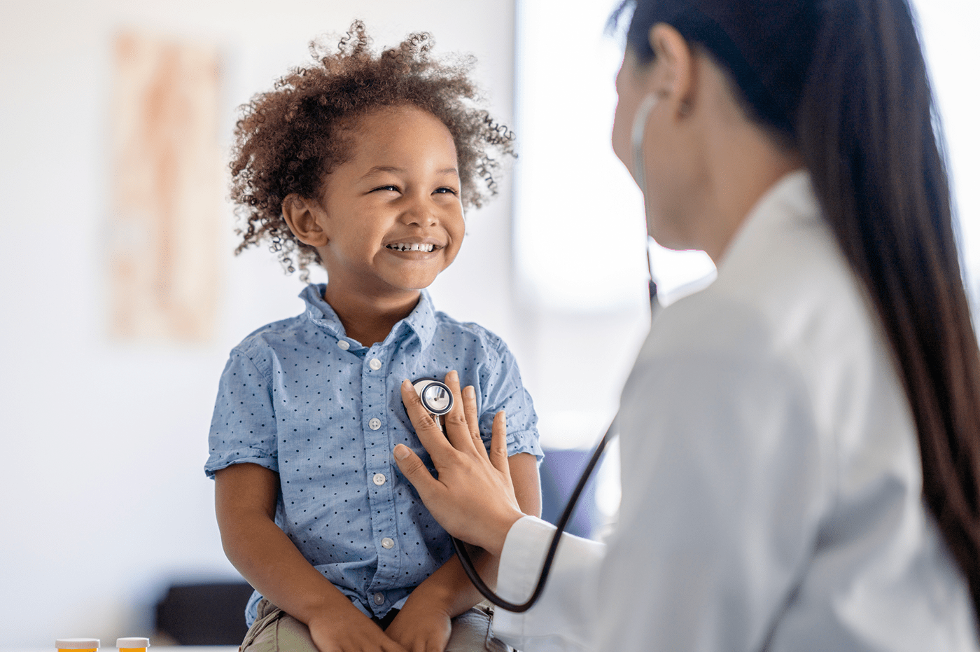 A Healthcare worker checking a child's heartbeat. 