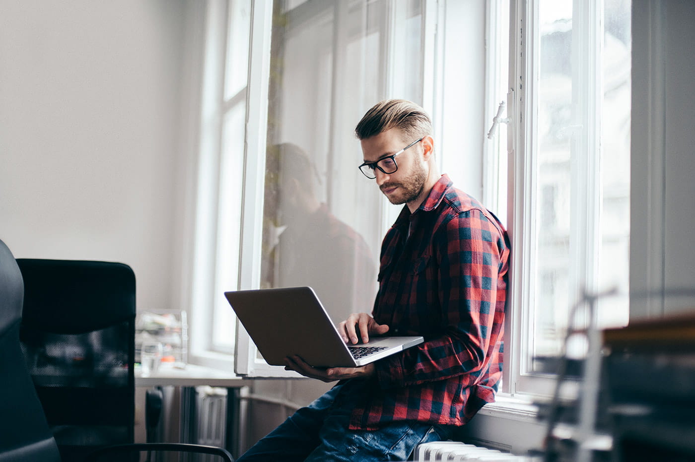 A young man working on a laptop.