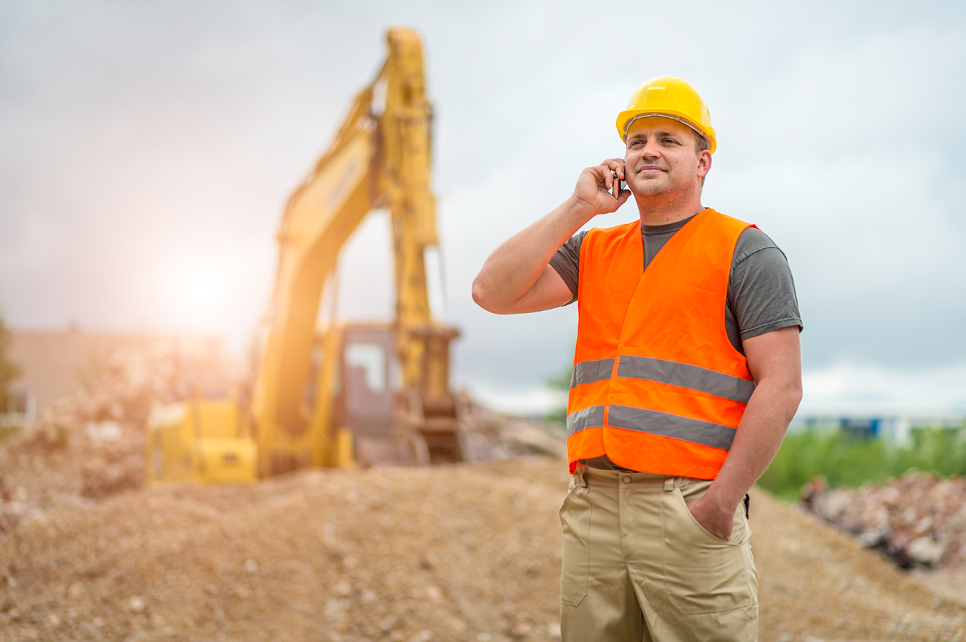 Constuction Worker on the phone at a job site