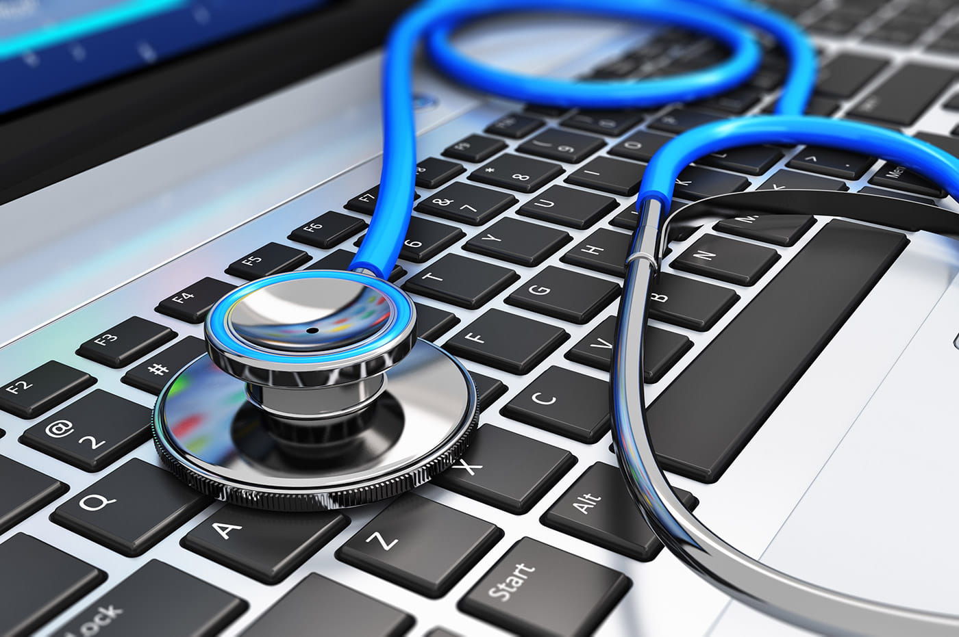 A stethoscope laying across a keyboard.