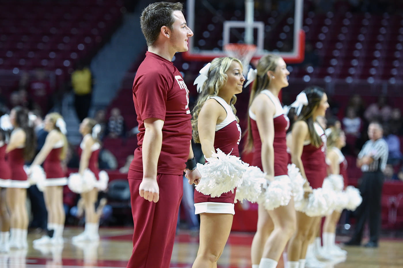 A group of cheerleaders in a gymnasium.