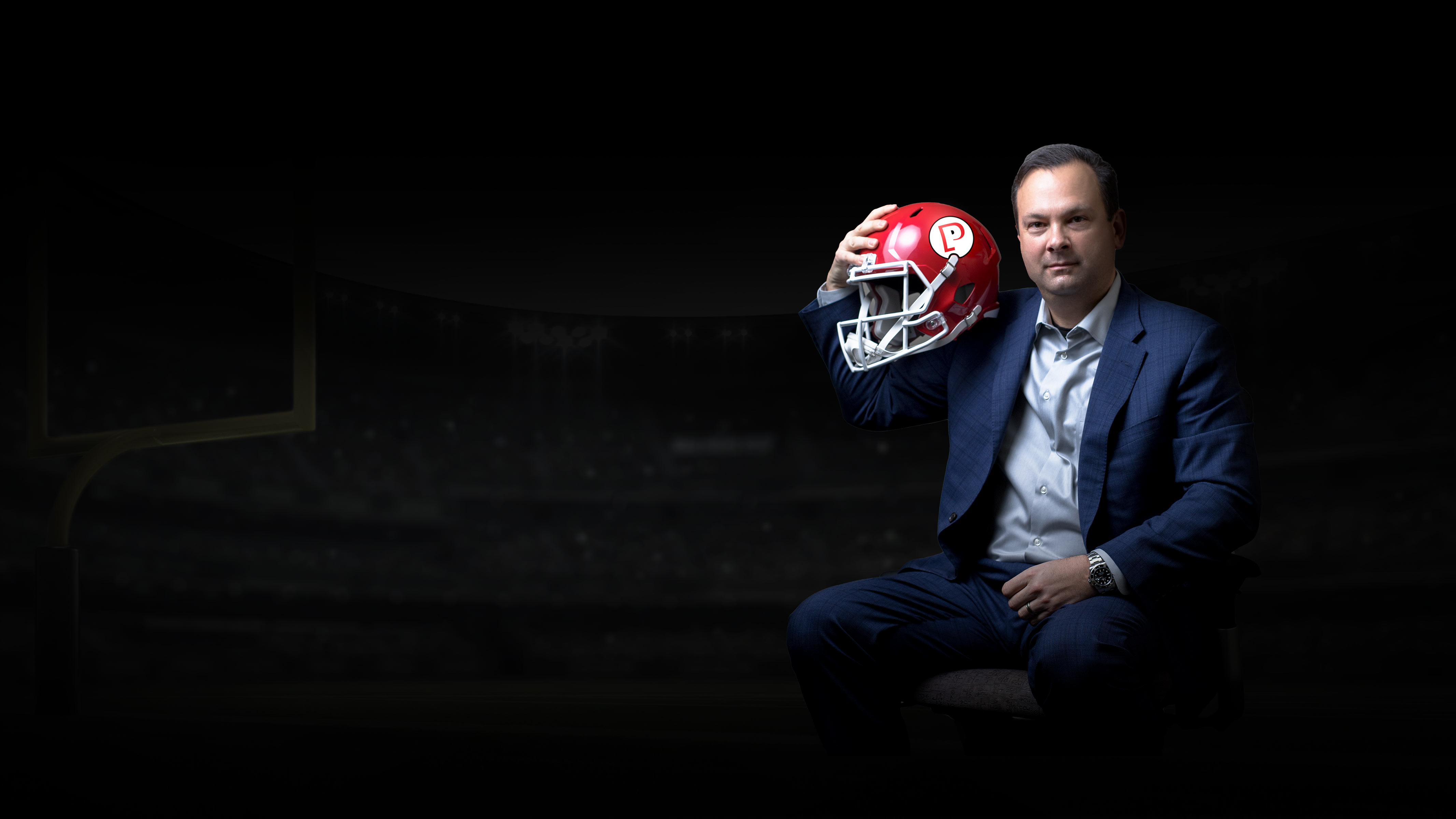 Patrick Schwierking, VP, Sales, holding a football helmet