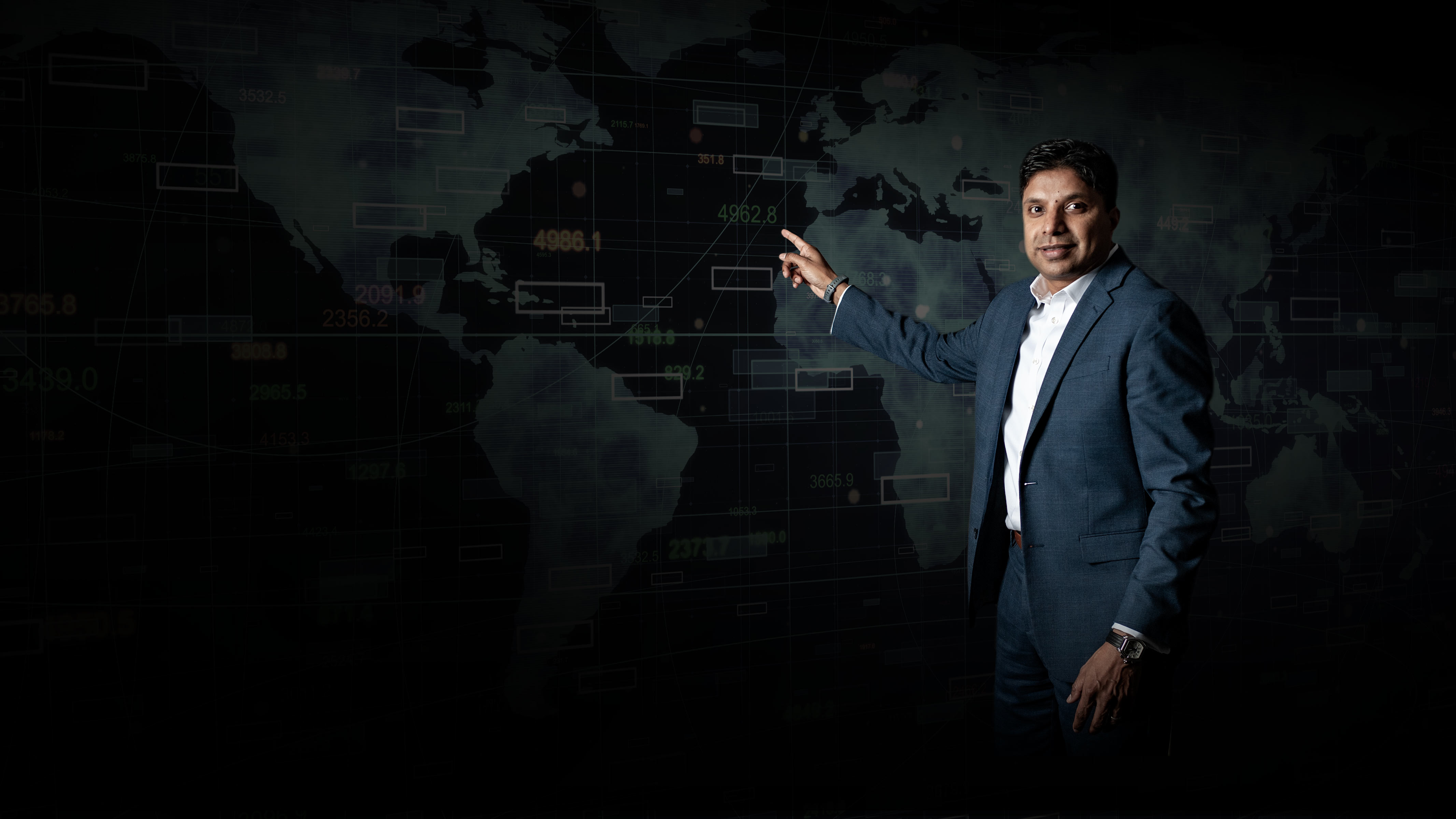 Santhosh Nair, VP, pointing to a map
