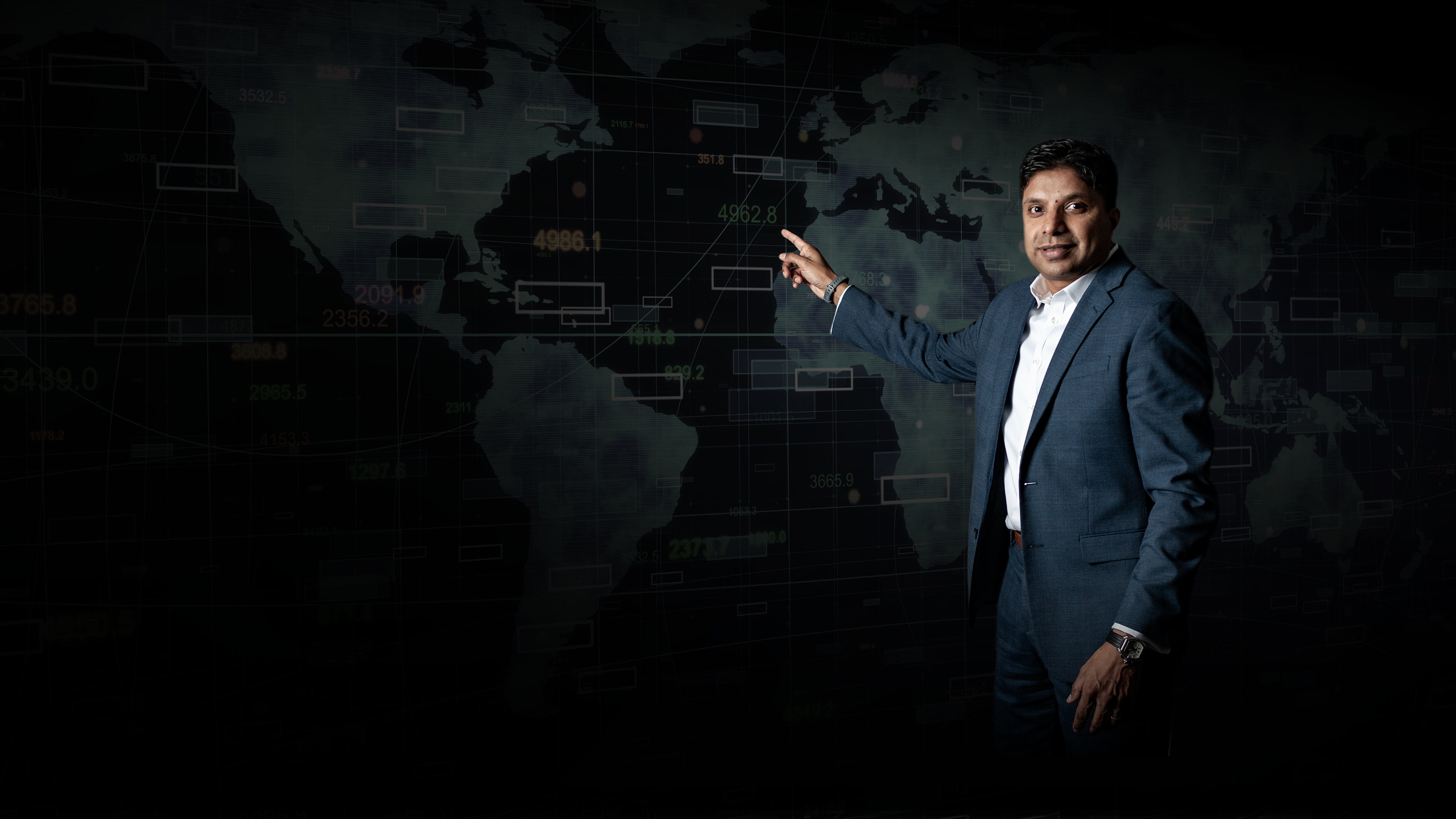 Santhosh Nair, VP, pointing to a map