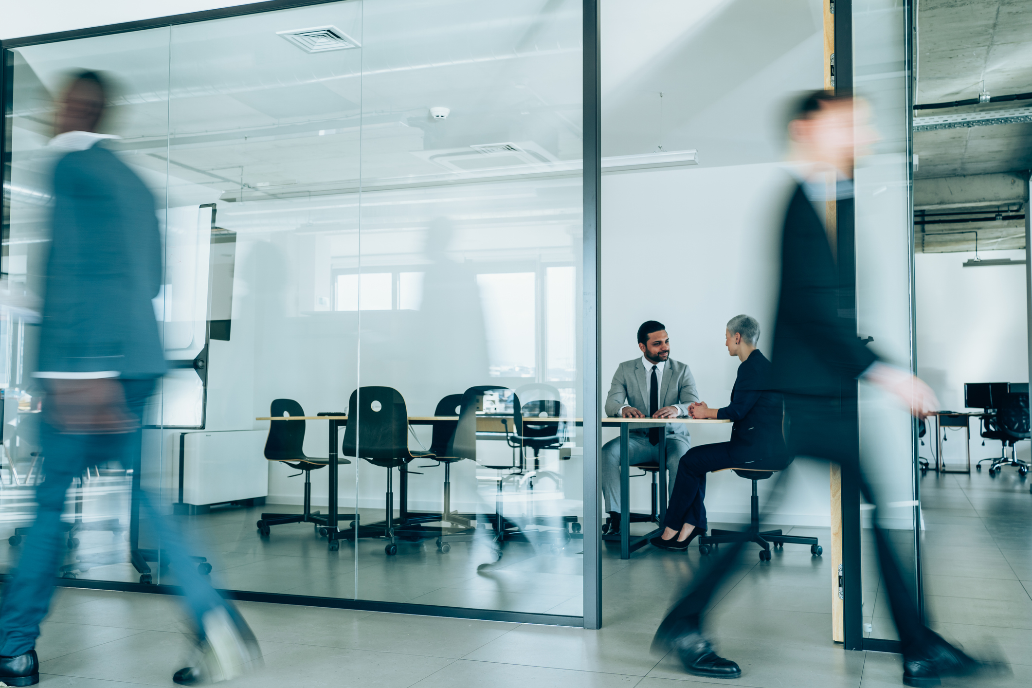 Two men in a meeting in a fast-paced office.