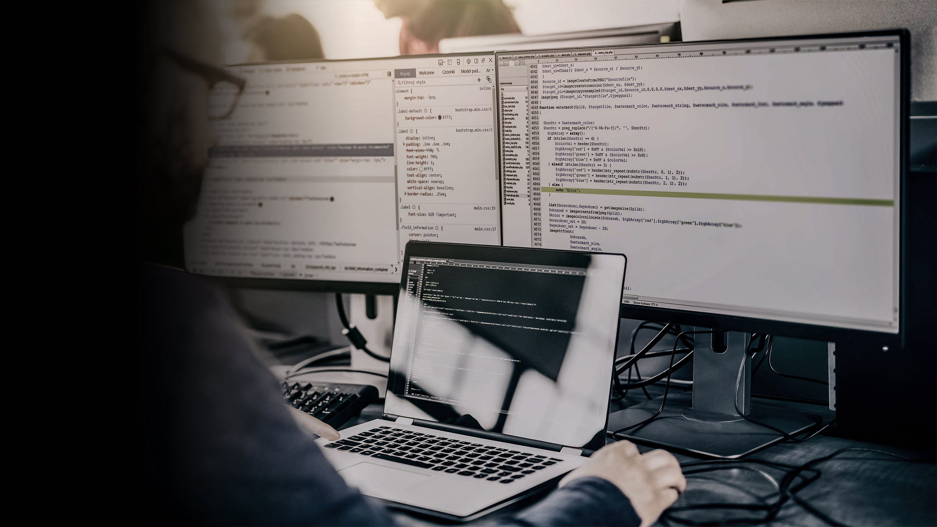 Man working on technical coding on multiple computer screens-gradient