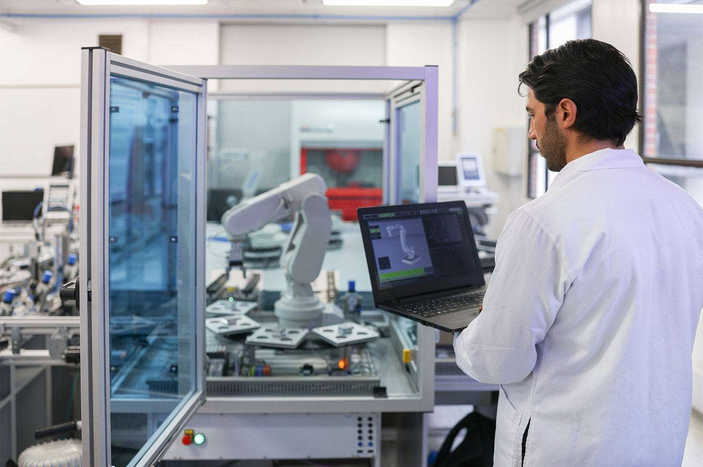 A person in a lab working with machinery and computers.