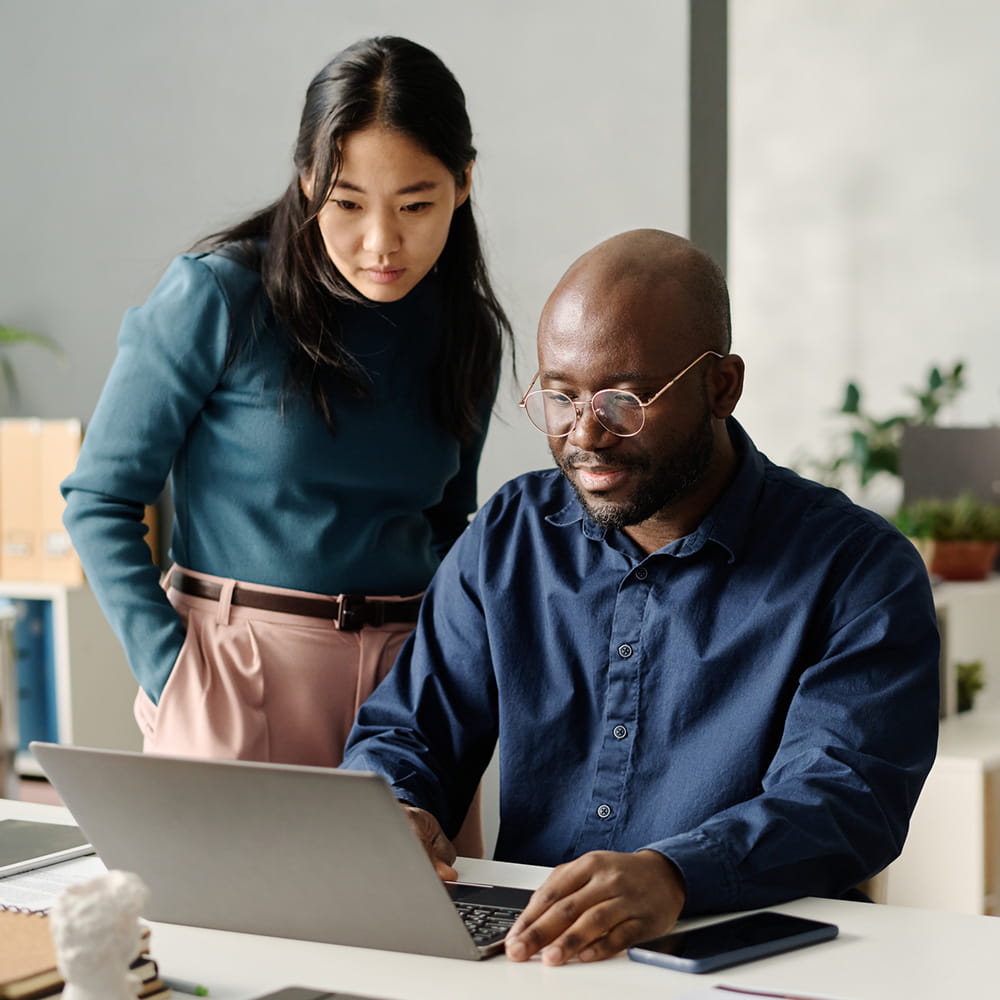Woman and man looking at a laptop