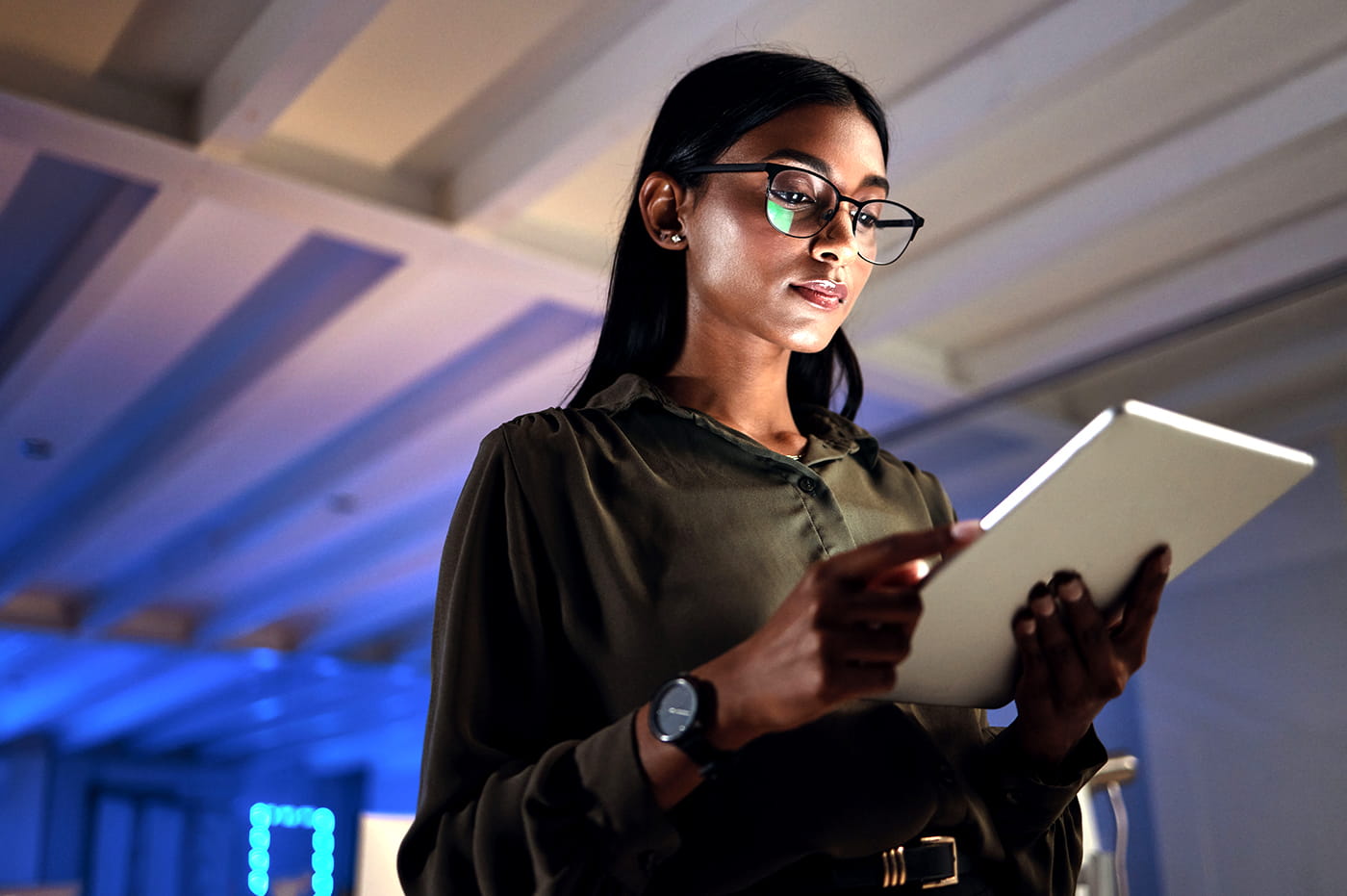 A woman working on a tablet.