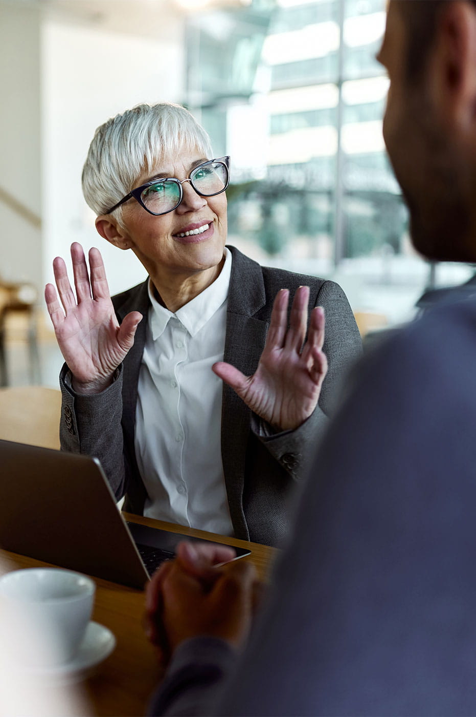 A woman talking to a colleague.