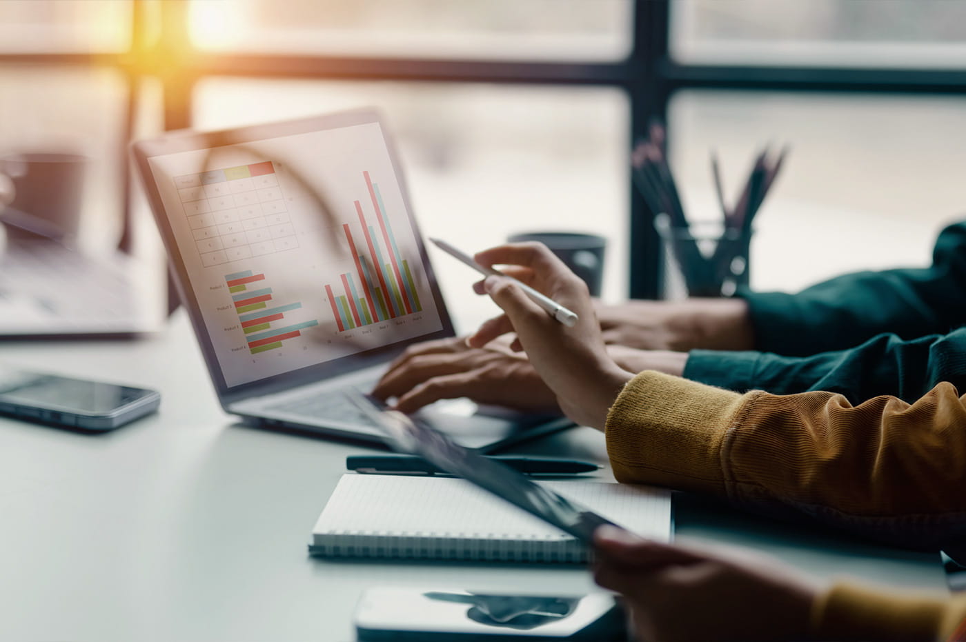 People looking at data on a laptop.
