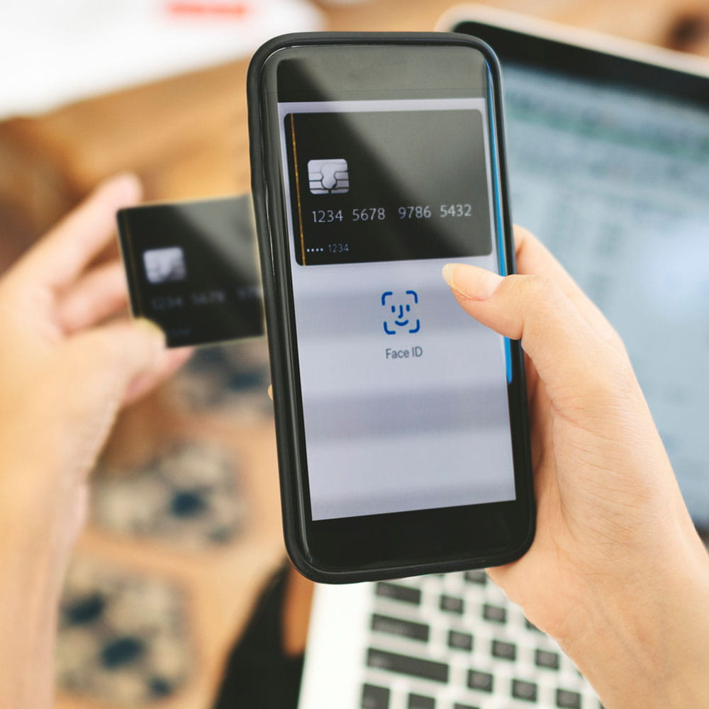 Person adding their credit card to their wallet on their cellphone and adding facial recognition. 