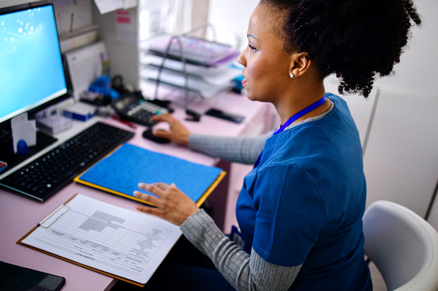 A healthcare worker on her computer.