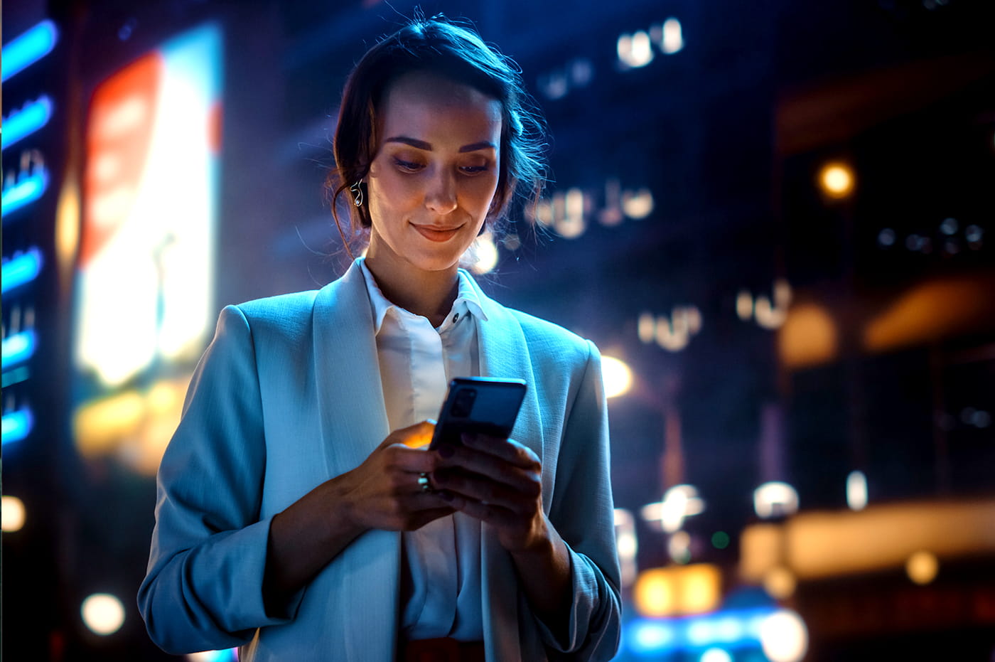 A woman looking at a smartphone.