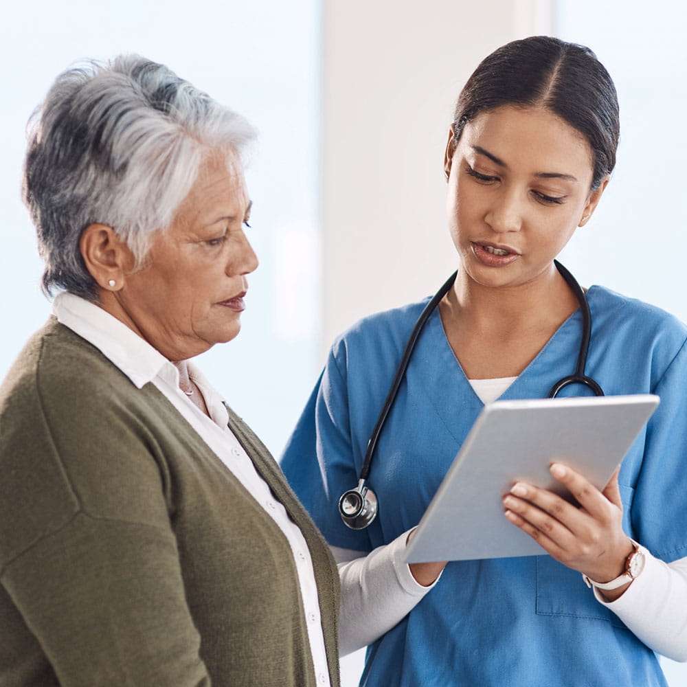 A healthcare worker and patient talking.