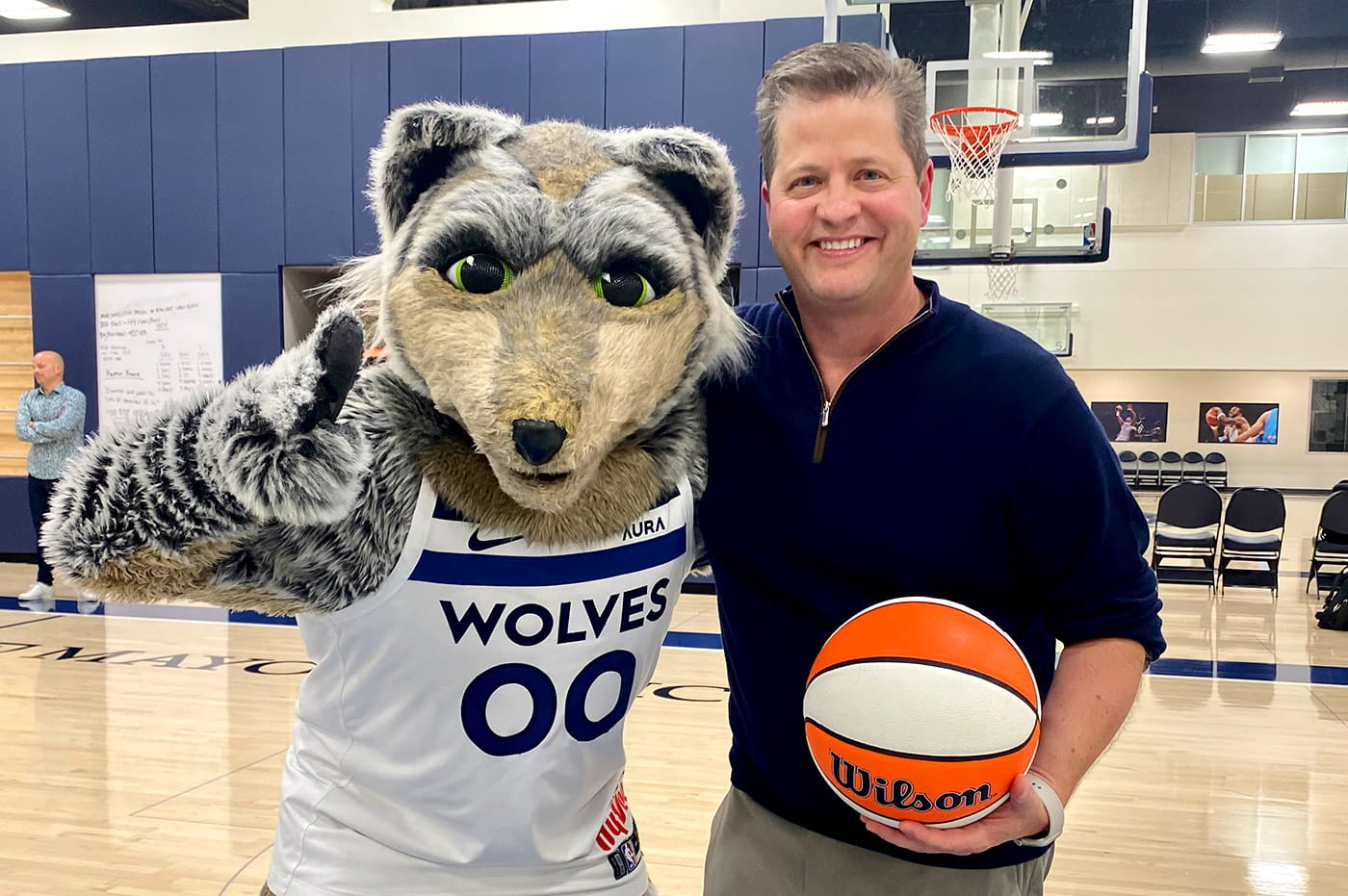 Bill Davis, SVP at Perficient, with the Minnesota Timberwolves' mascot, Crunch.