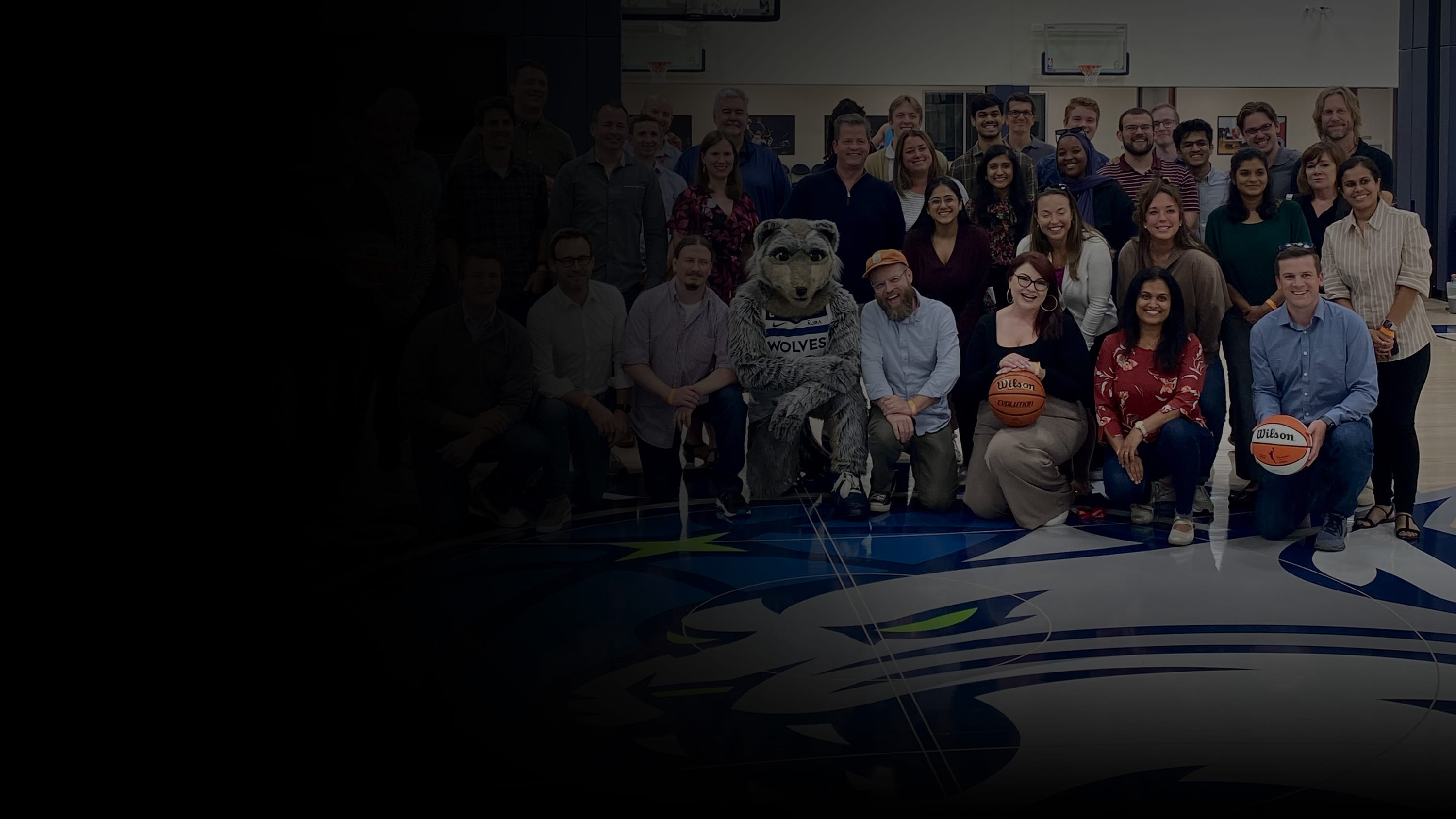 Perficient colleagues with the Minnesota Timberwolves' mascot, Crunch.