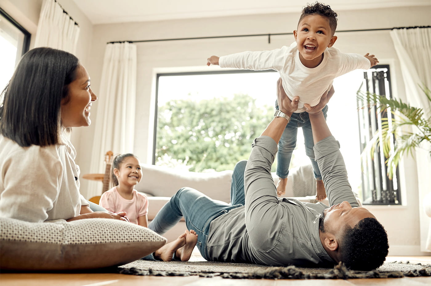 A young family playing and laughing together.